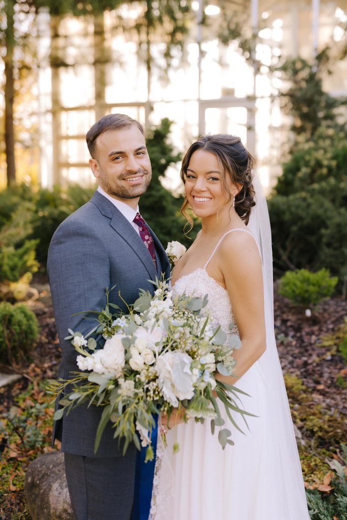 bride and groom look at wedding photographer during Atlanta wedding photos