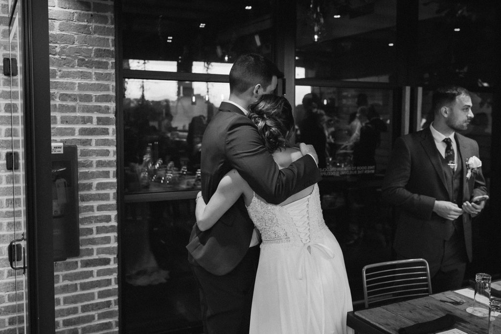 bride hugs guest during Downtown Atlanta wedding reception