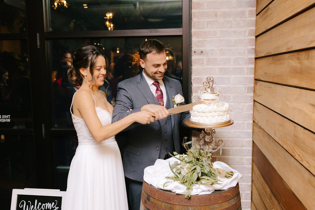 bride and groom cut wedding cake during Downtown Atlanta reception