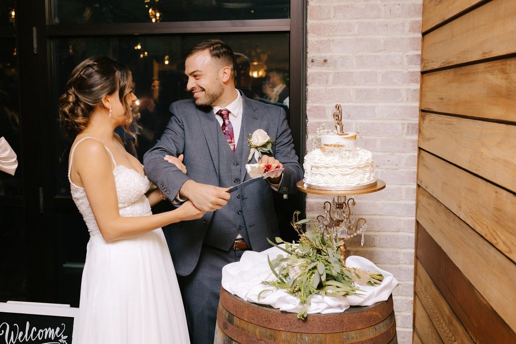 bride and groom cut wedding cake during Downtown Atlanta reception