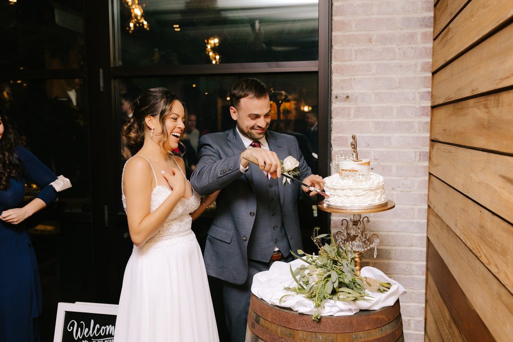 bride and groom cut wedding cake during Downtown Atlanta reception