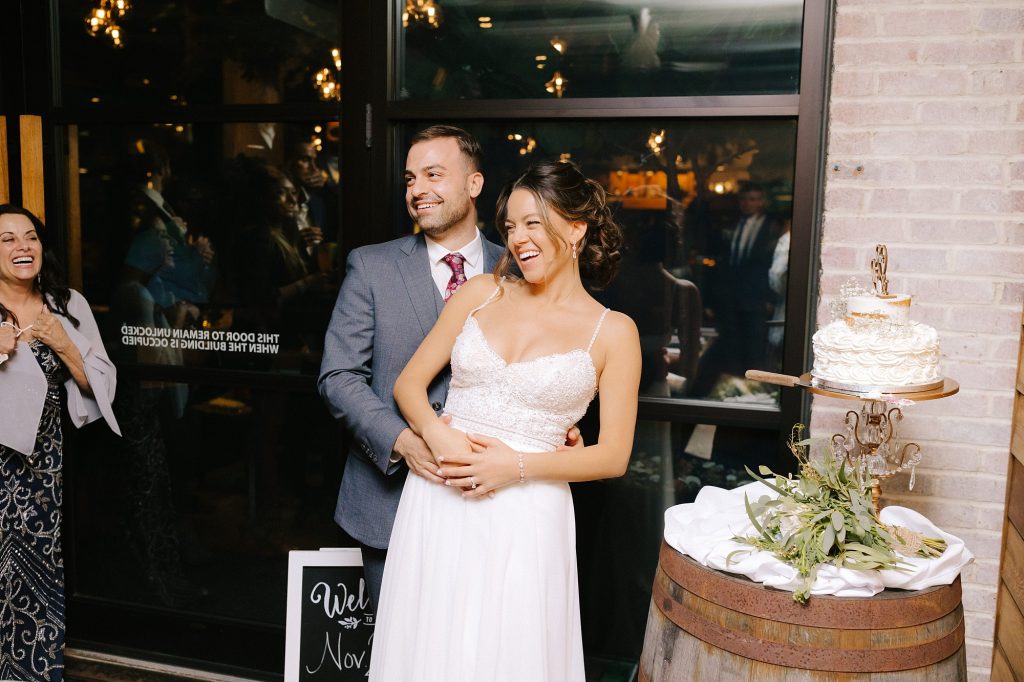 bride and groom hug on rooftop of Atlanta bar