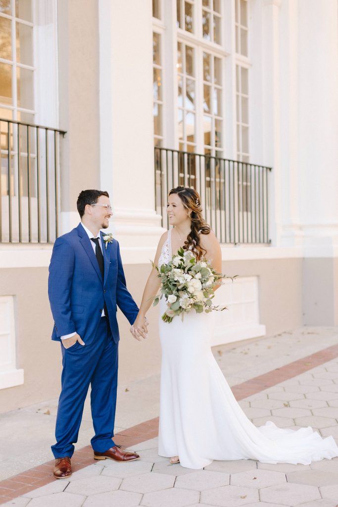 bride and groom pose by hotel in downtown Lakeland 