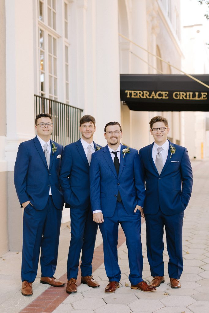 groom poses with groomsmen in downtown Lakeland