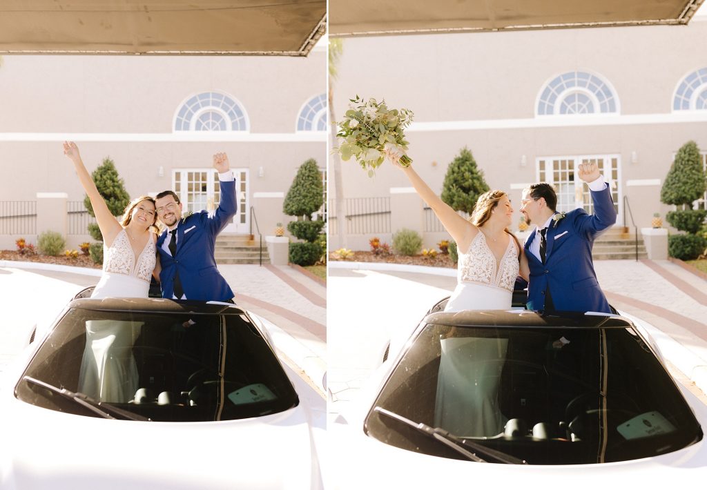 newlyweds pose in back of white sports car cheering