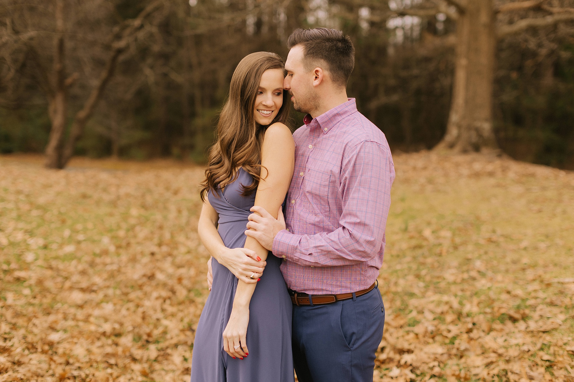 groom kisses bride's forehead during Jetton Park engagement session