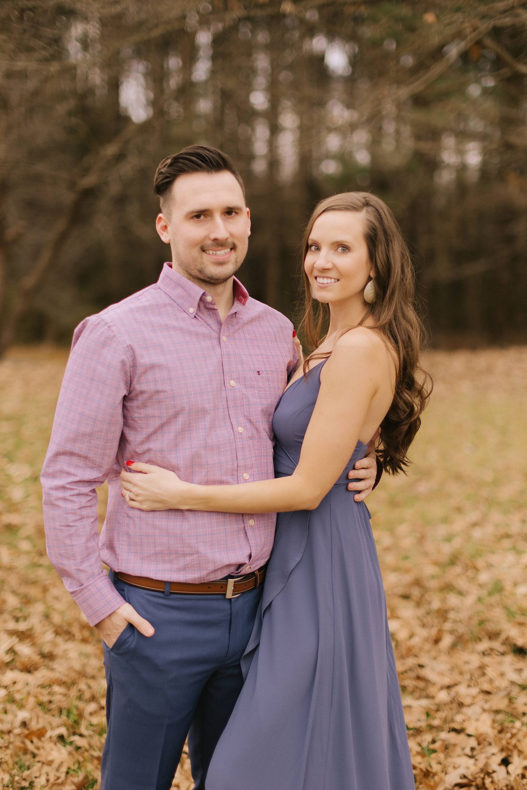 engaged couple hugs during fall engagement photos in Jetton Park