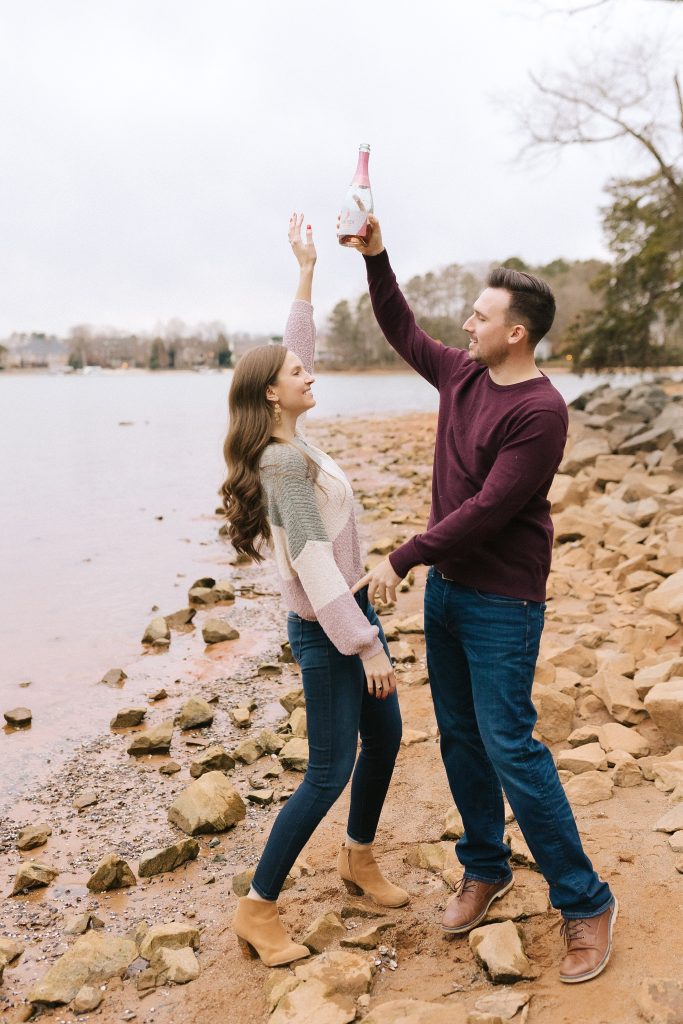 engaged couple toasts during photos at Jetton Park