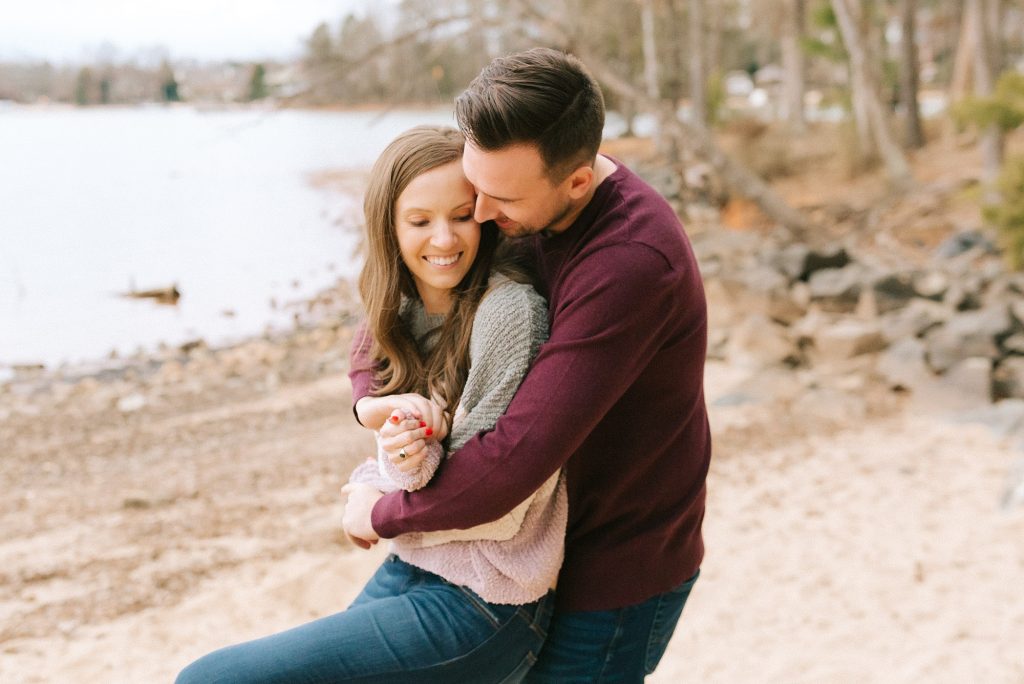 Jetton Park engagement session with couple hugging on beach