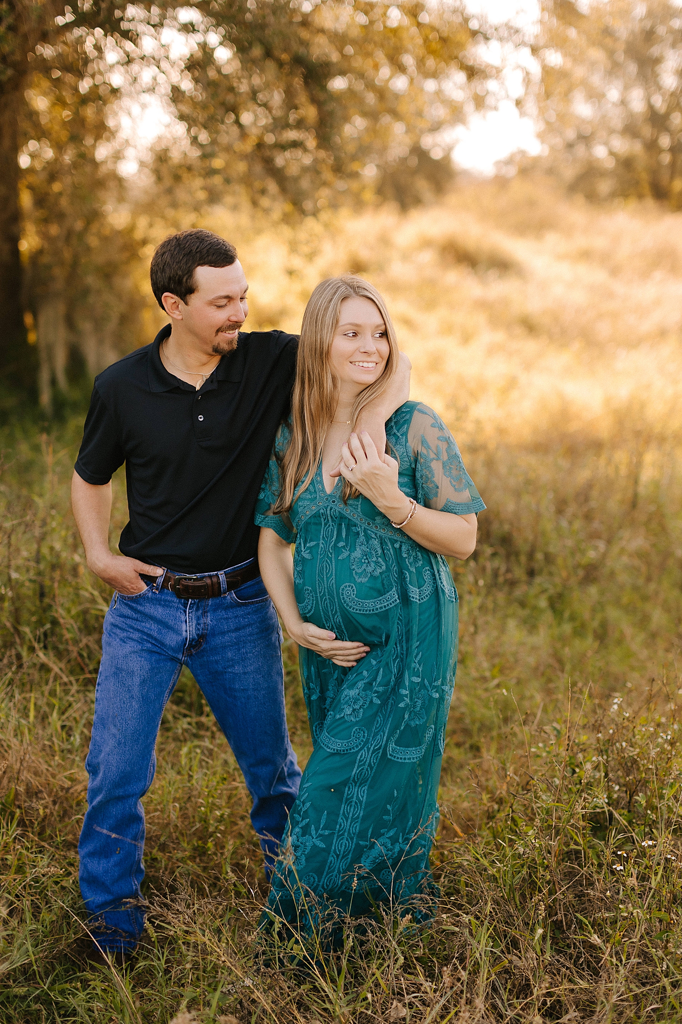 dad holds mom around shoulders during Winston Salem maternity photos