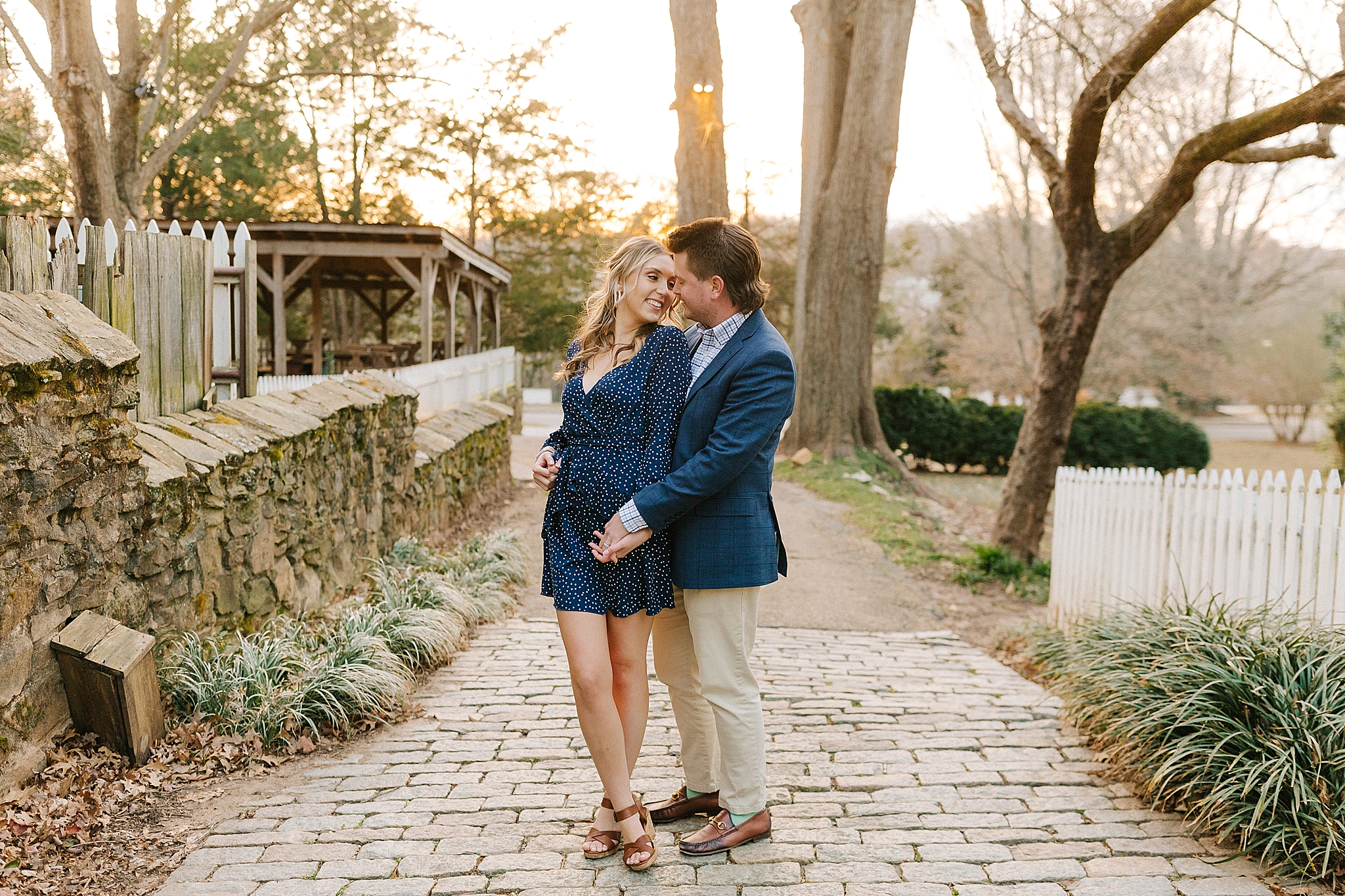 groom hugs bride in navy blue dress during NC engagement photos