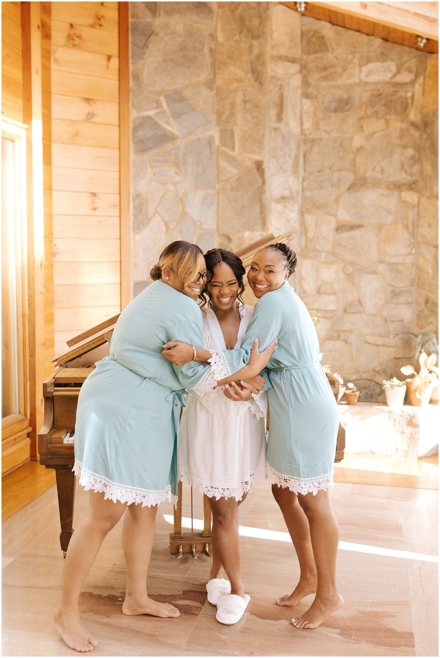 Bridesmaids hugging the bride on wedding morning in Raleigh, NC