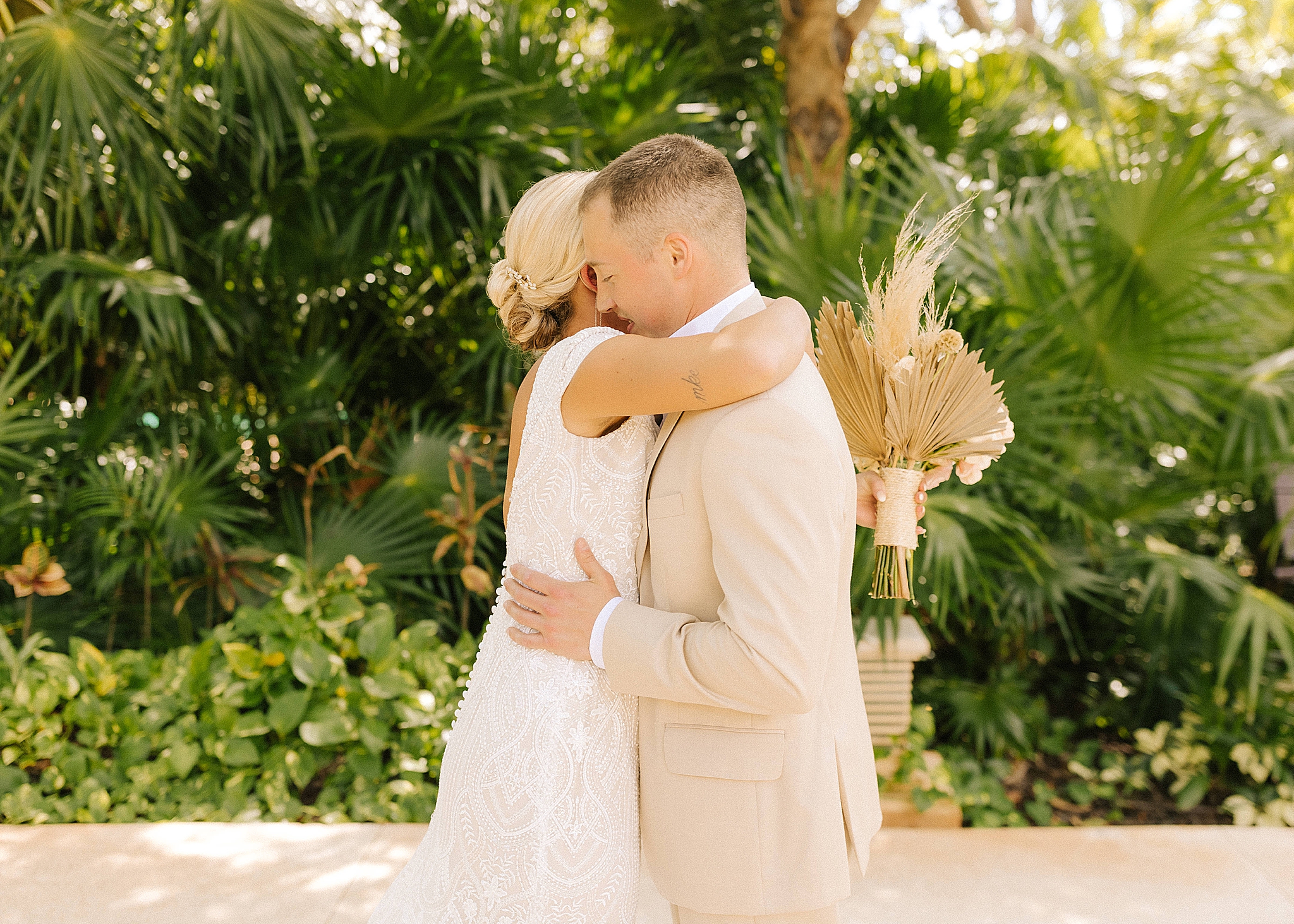 bride and groom hug during first look at Sandos Playacar