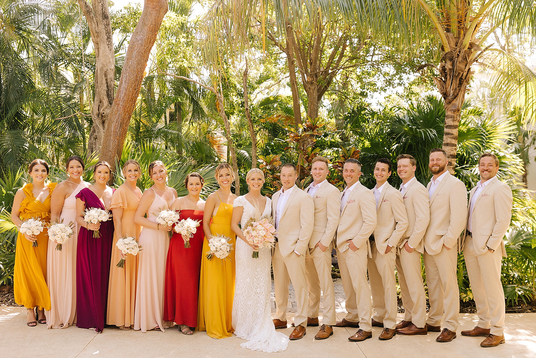 bridal party poses with newlyweds during Playa Del Carmen destination wedding