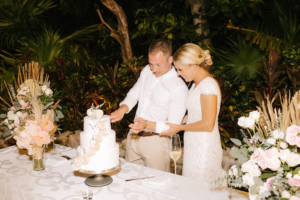 bride and groom cut wedding cake at destination wedding