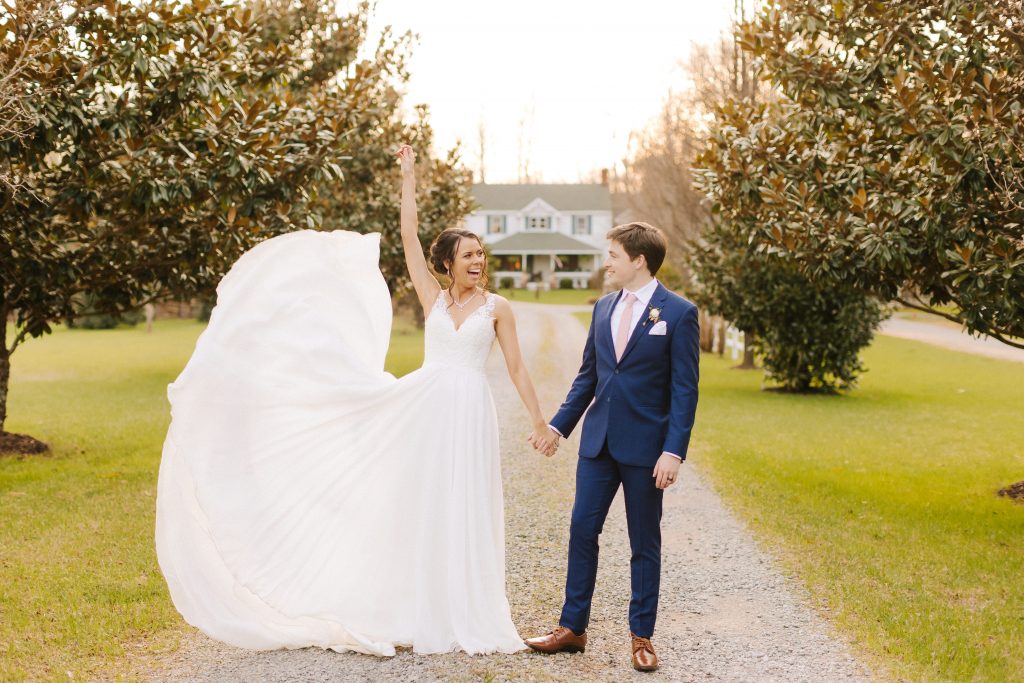 bride tosses gown while holding hands with groom