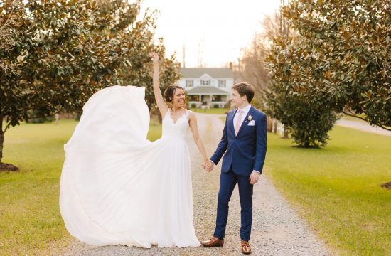 bride tosses gown while holding hands with groom