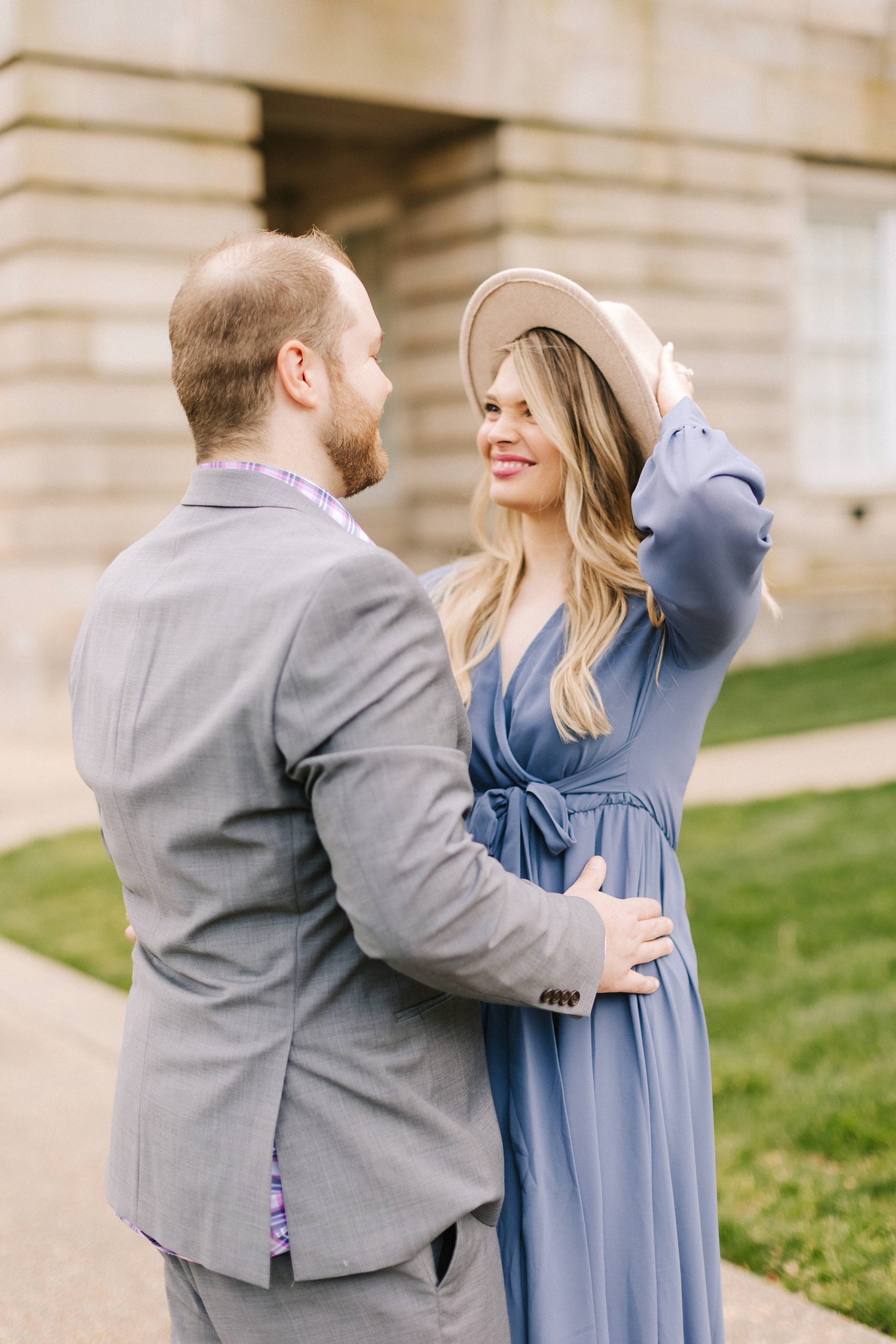 bride and groom laugh together during Downtown Raleigh engagement photos 