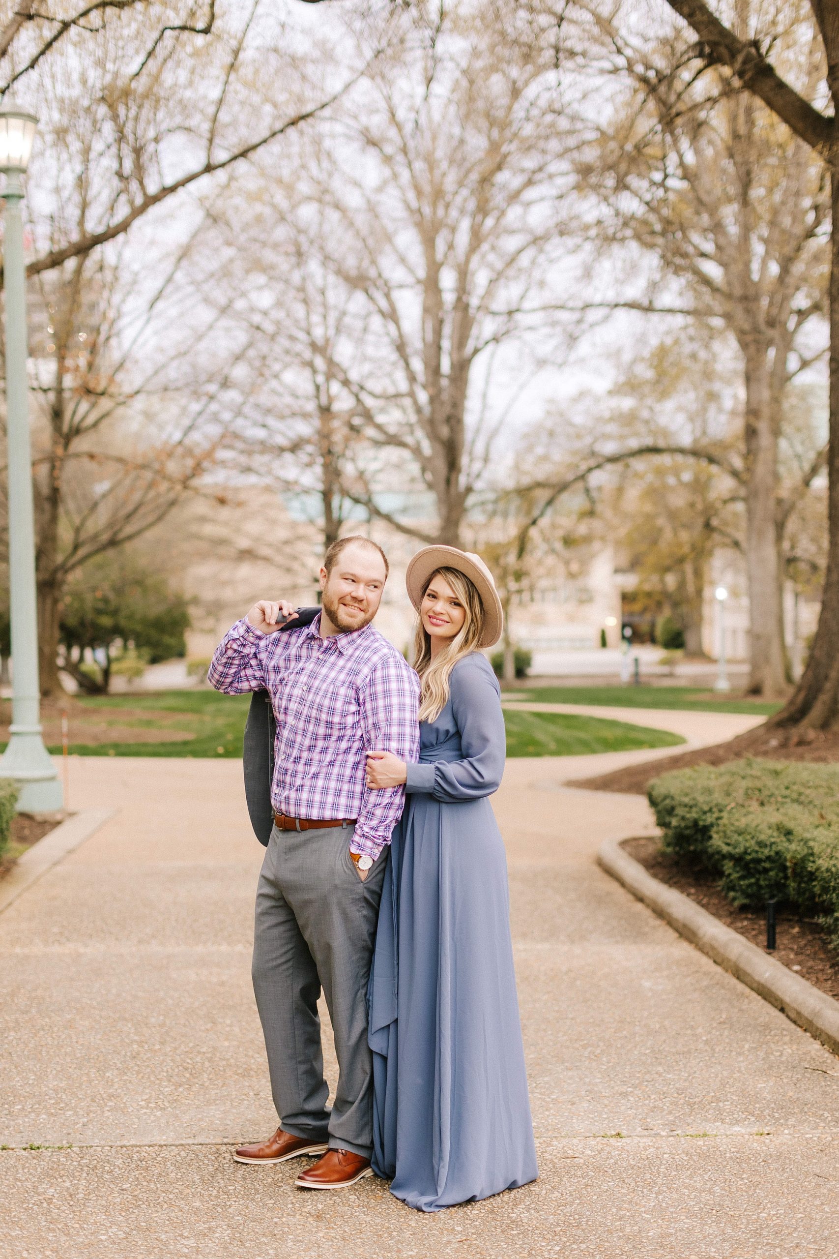 bride and groom pose on sidewalk in Raleigh NC
