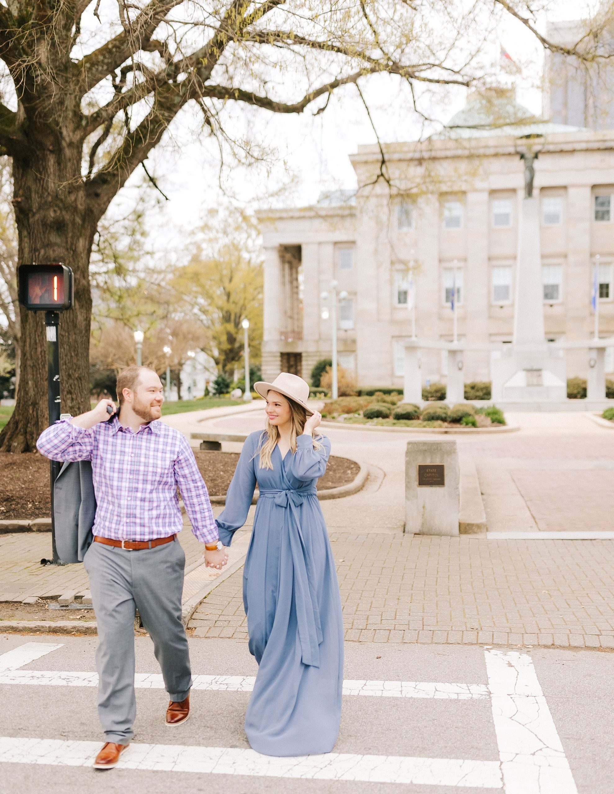 engaged couple walks through Raleigh NC crosswalk