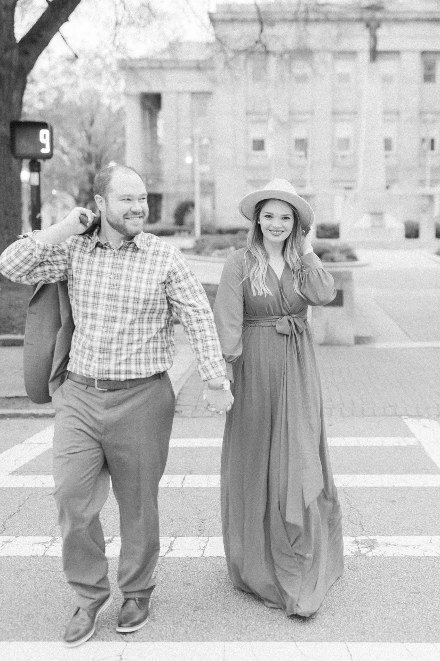bride and groom walk through crosswalk in Raleigh NC