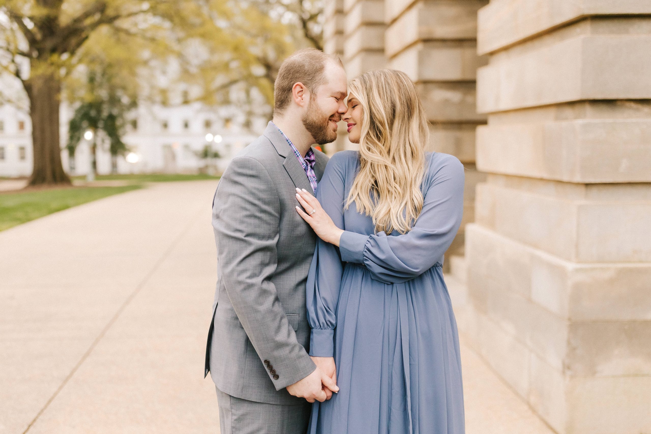Engaged Couple in front of the capital building in Raleigh, NC