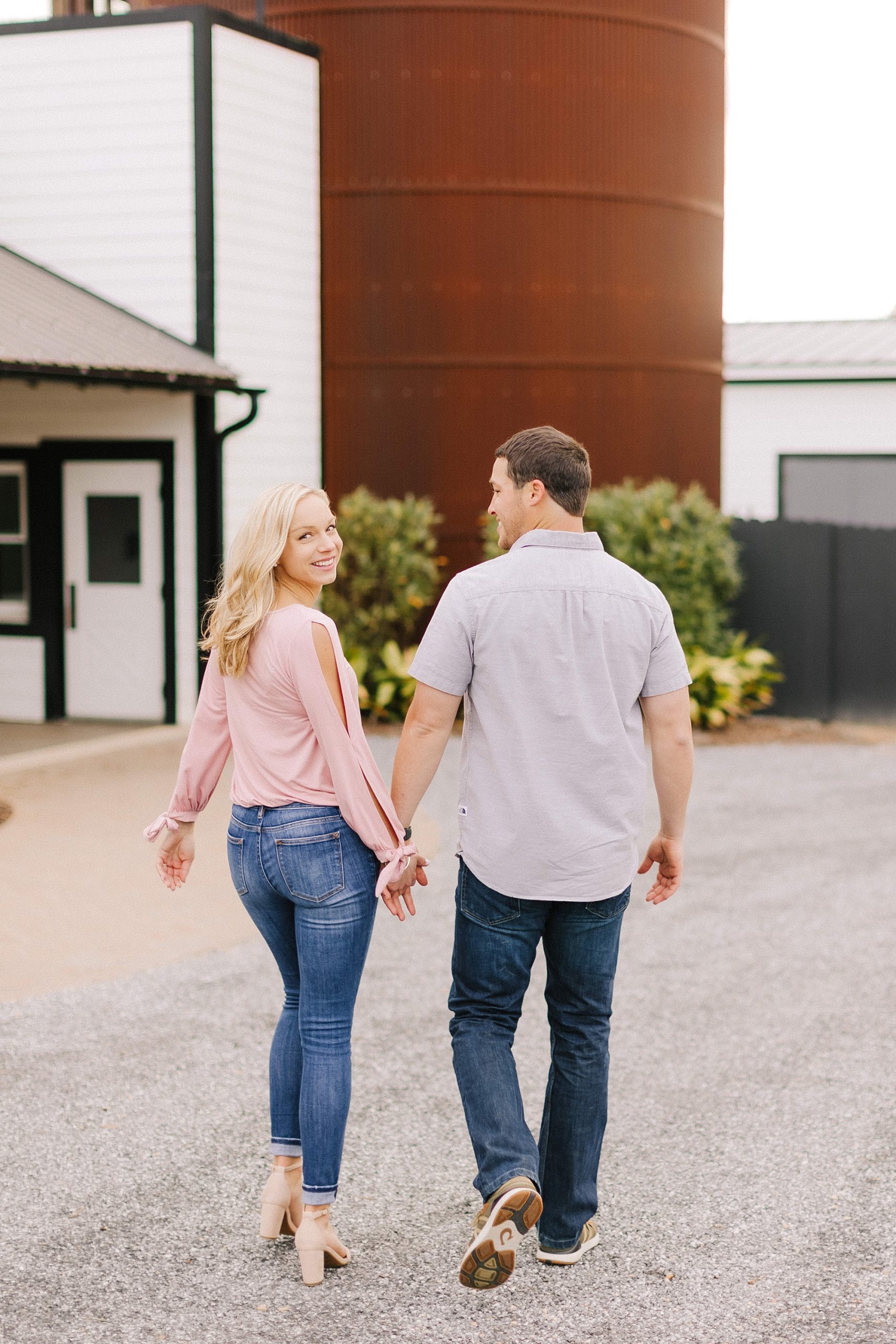 engaged couple walks together on NC farm