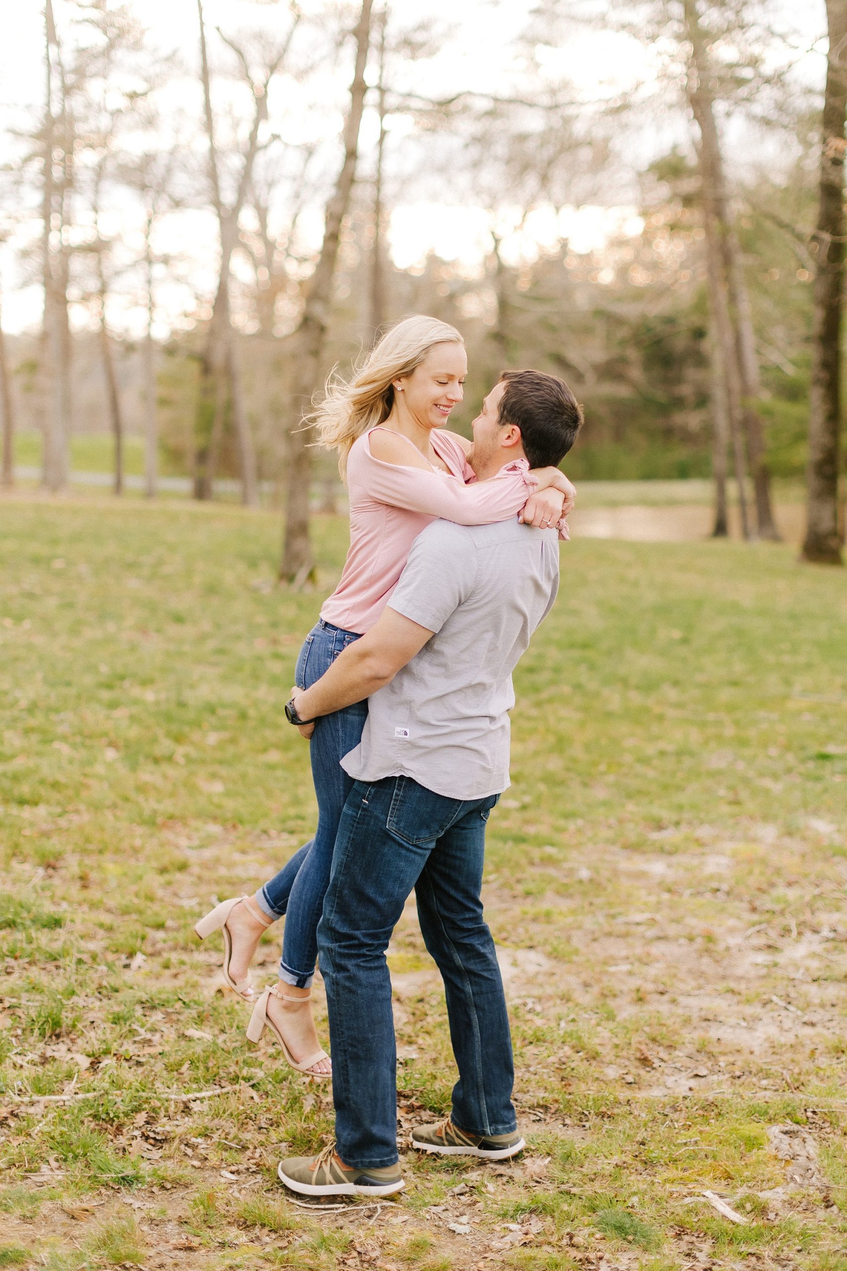 groom lifts bride up during NC engagement photos