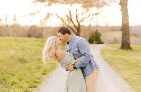 groom kisses fiancee during Summerfield Farms engagement session
