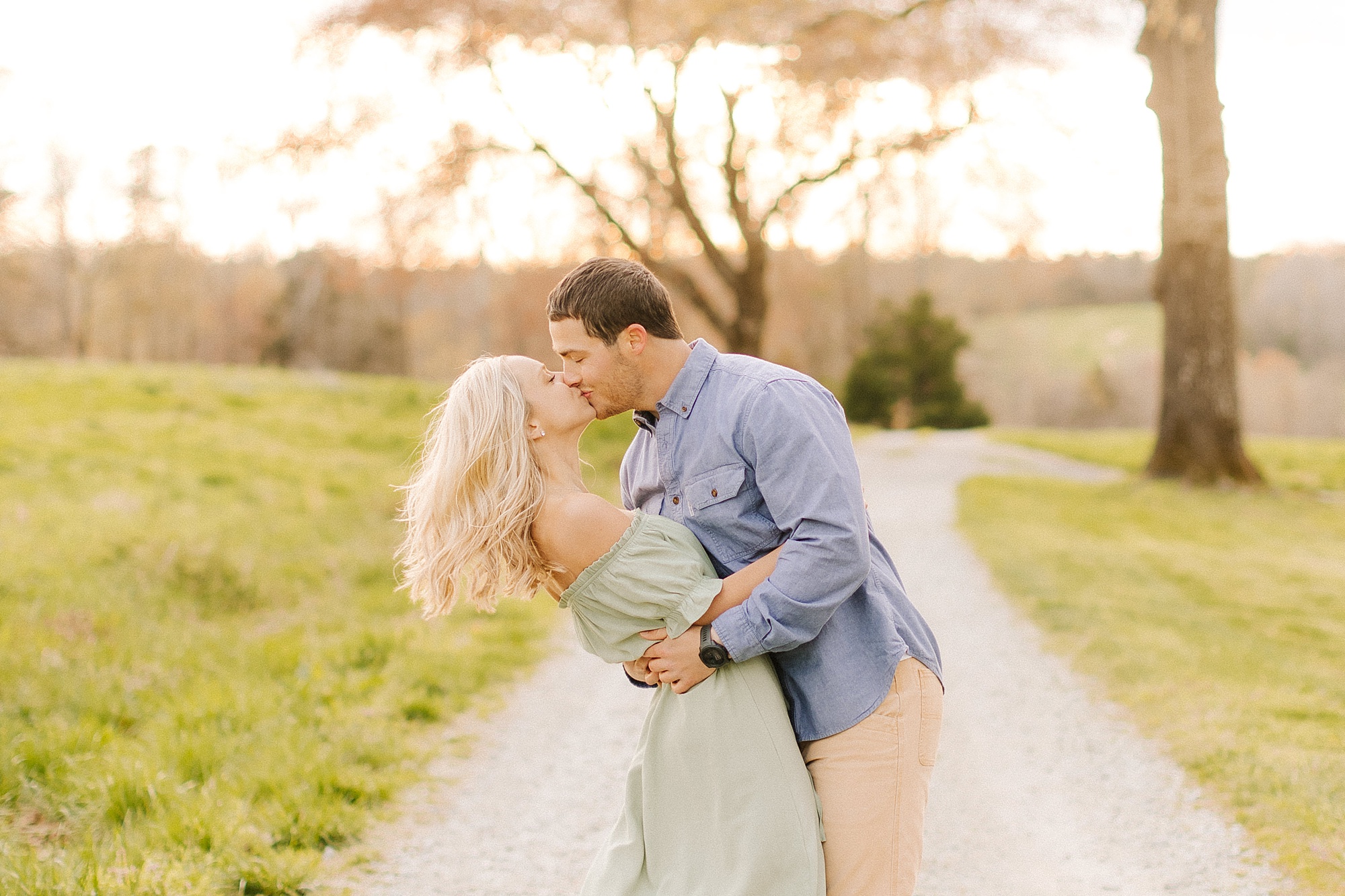 groom kisses fiancee during Summerfield Farms engagement session