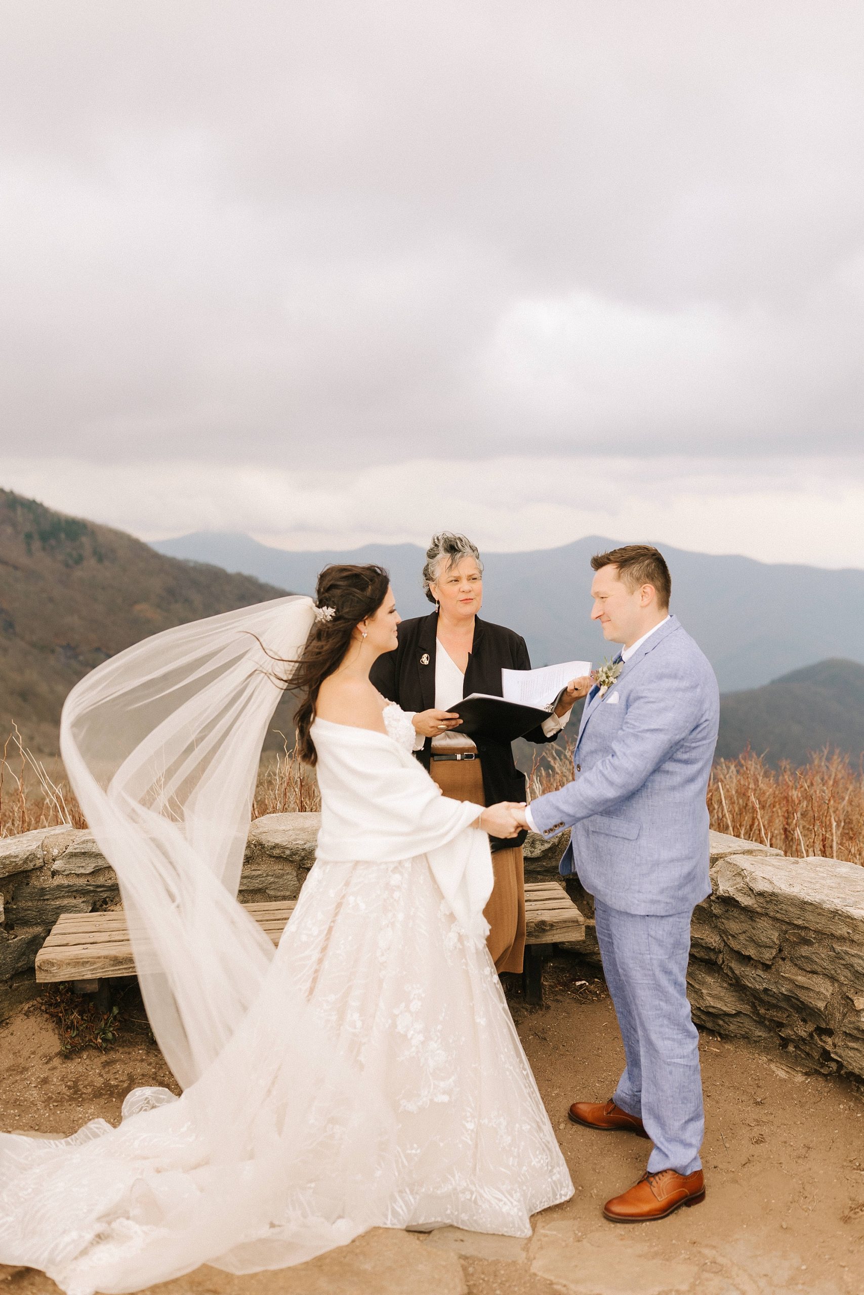 groom reads vows to bride during Asheville Elopement at Craggy Pinnacle