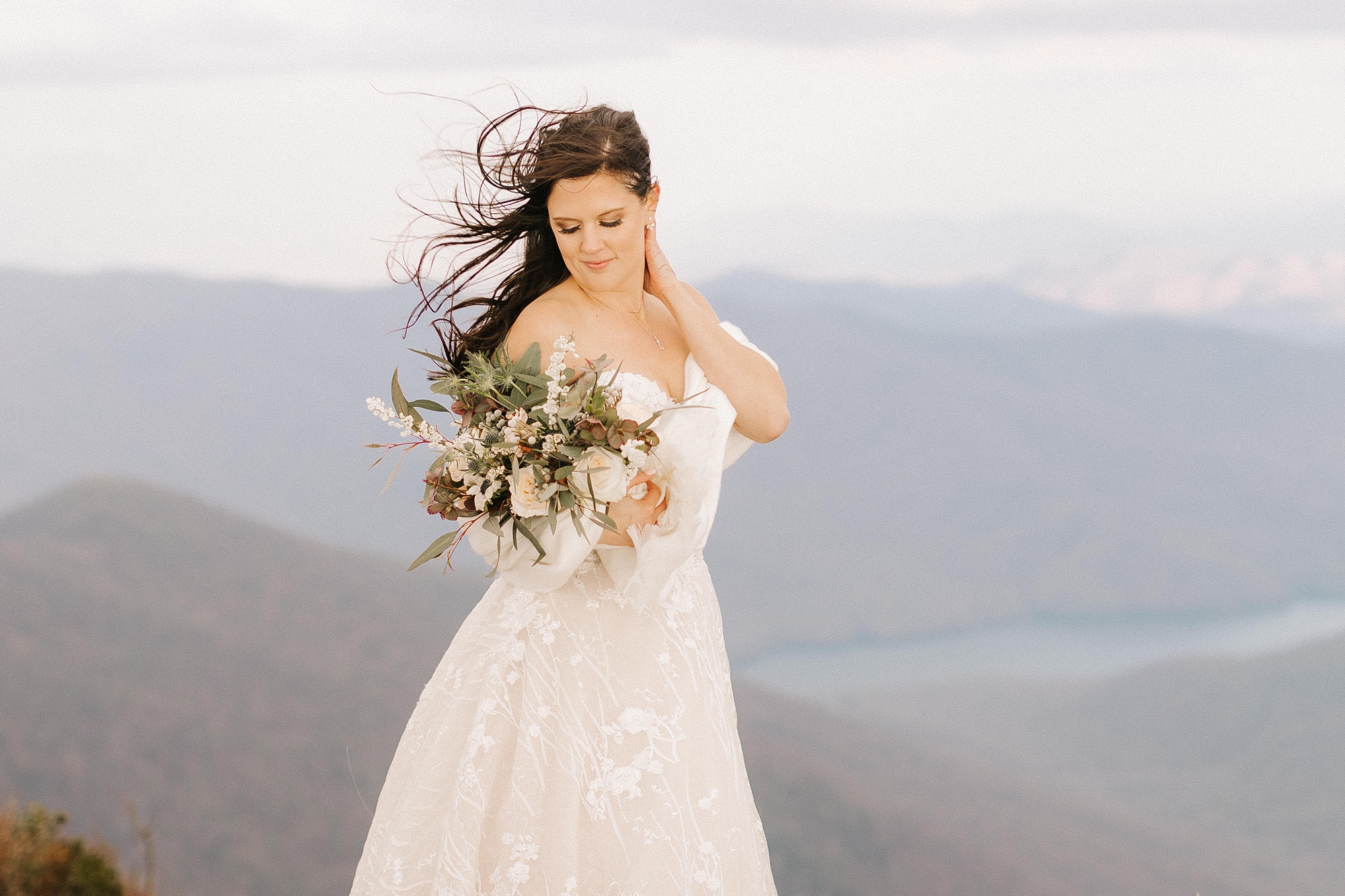 bride looks down bouquet during Asheville Elopement at Craggy Pinnacle wedding portraits 