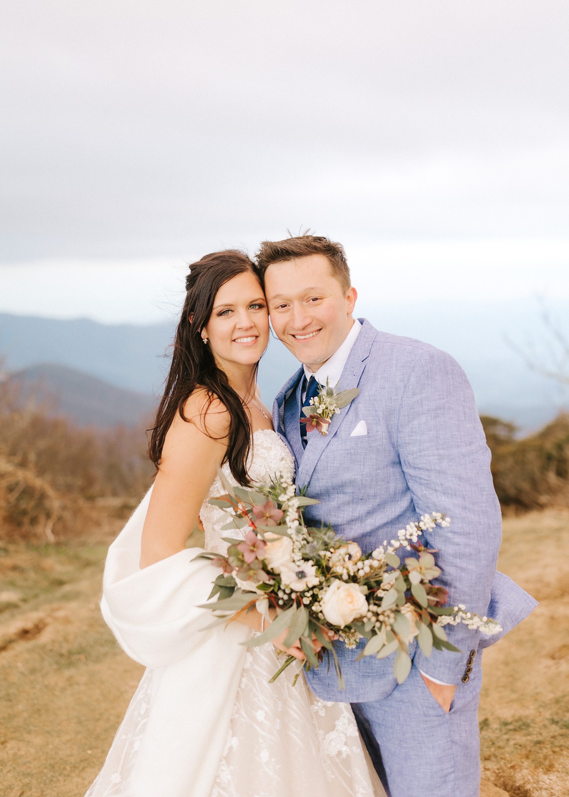 newlyweds lean together during Asheville Elopement portraits at Craggy Pinnacle