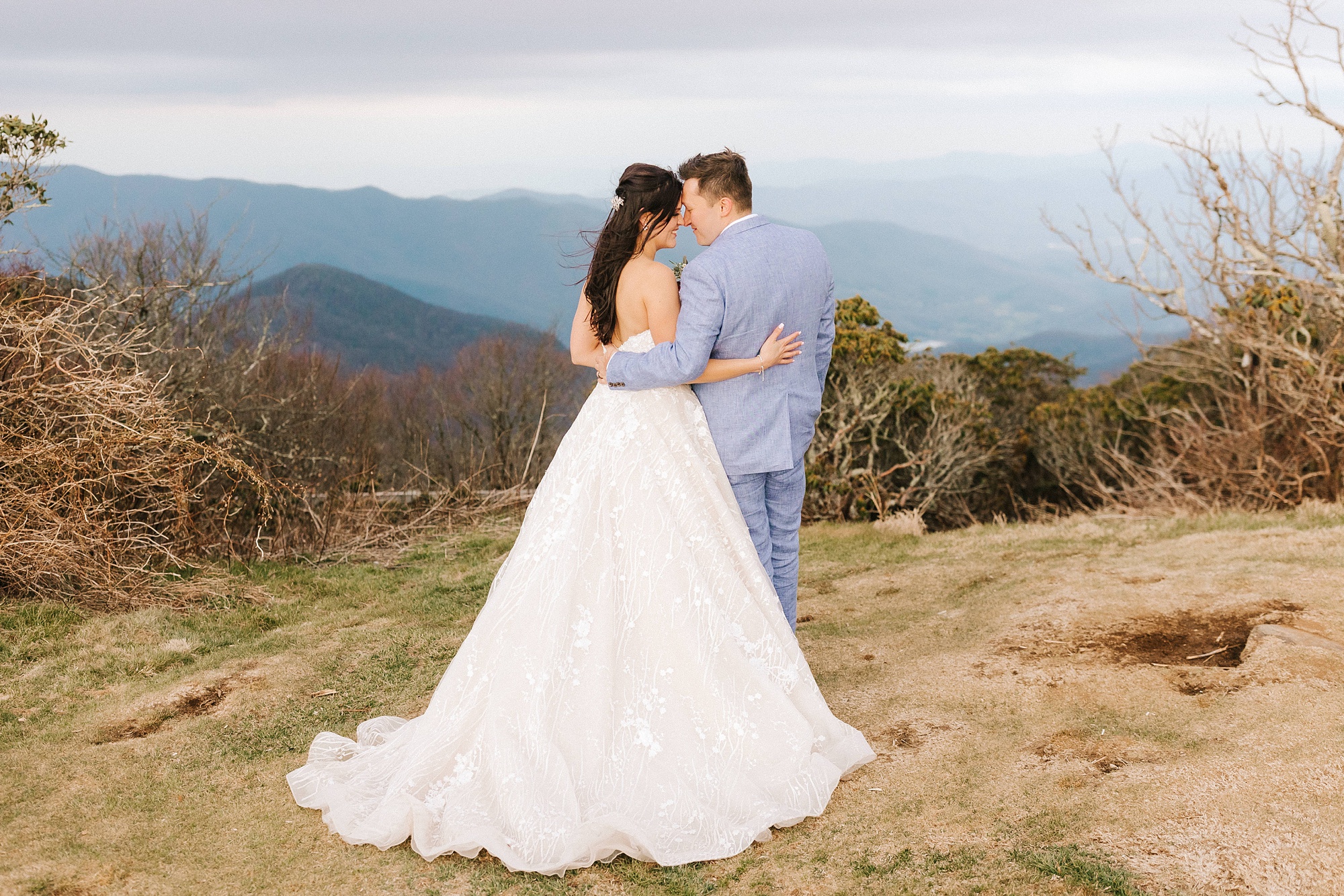 newlyweds pose on top of mountain in Asheville 
