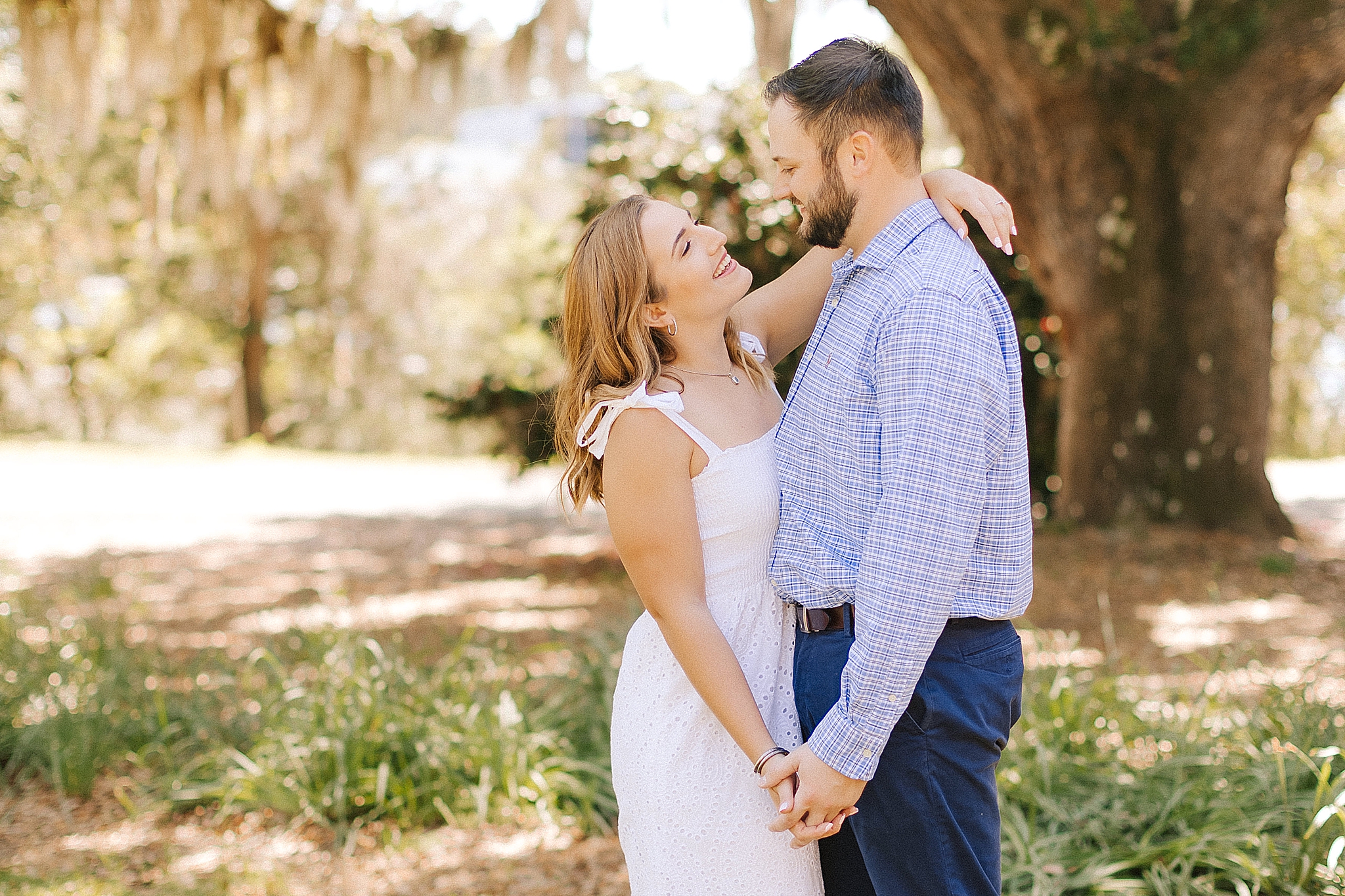 engaged couple dances in Airlie Gardens during Wilmington engagement session