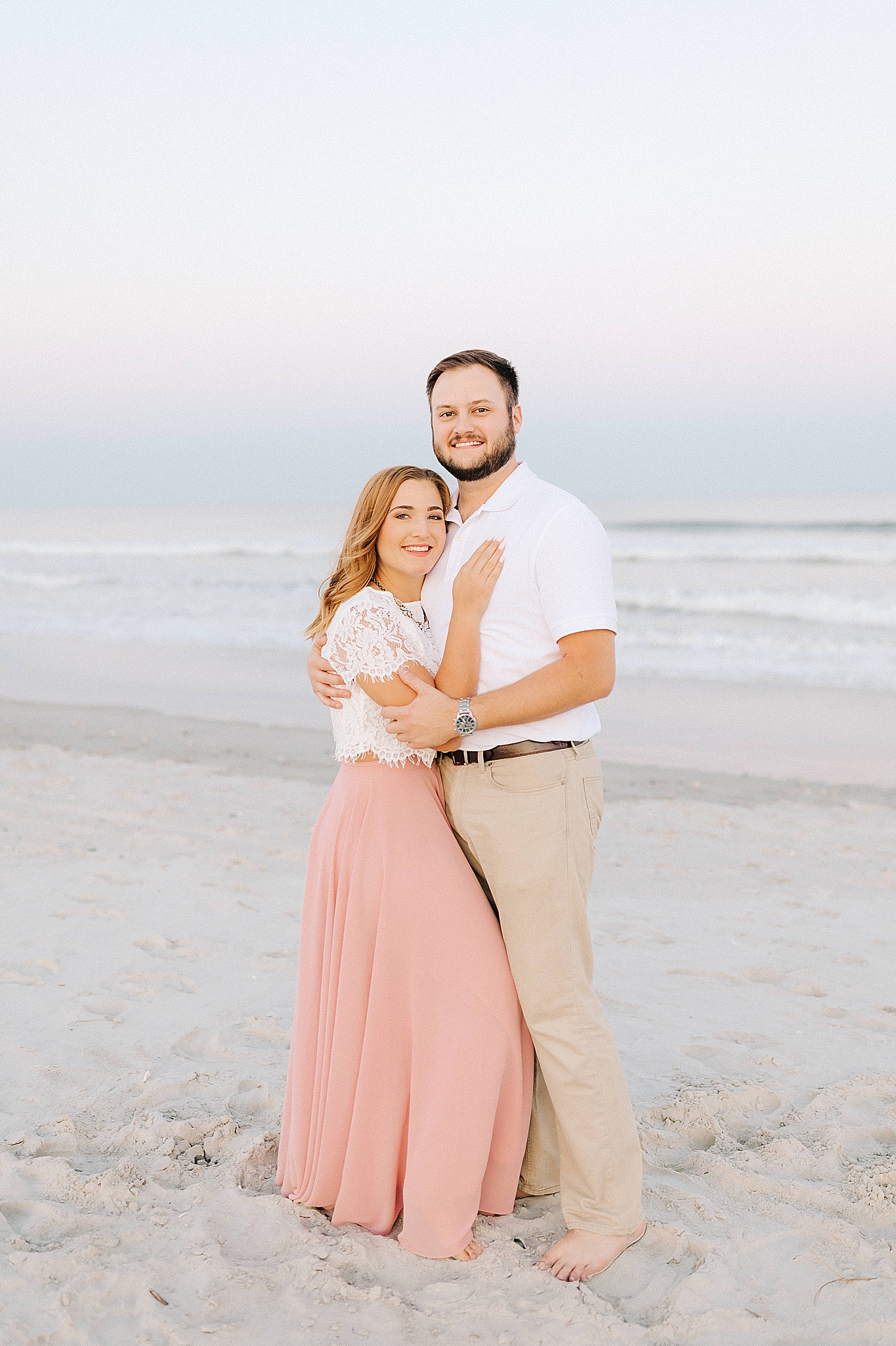 groom holds bride on beach in Wilmington NC