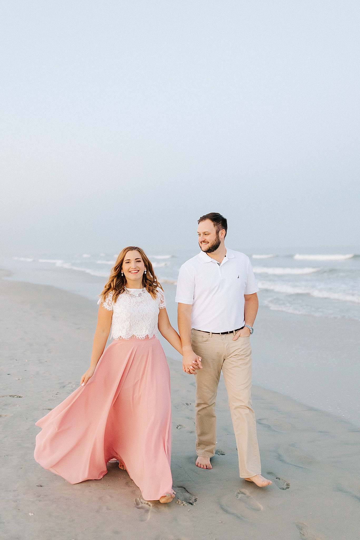 engaged couple walks on Wrightsville Beach