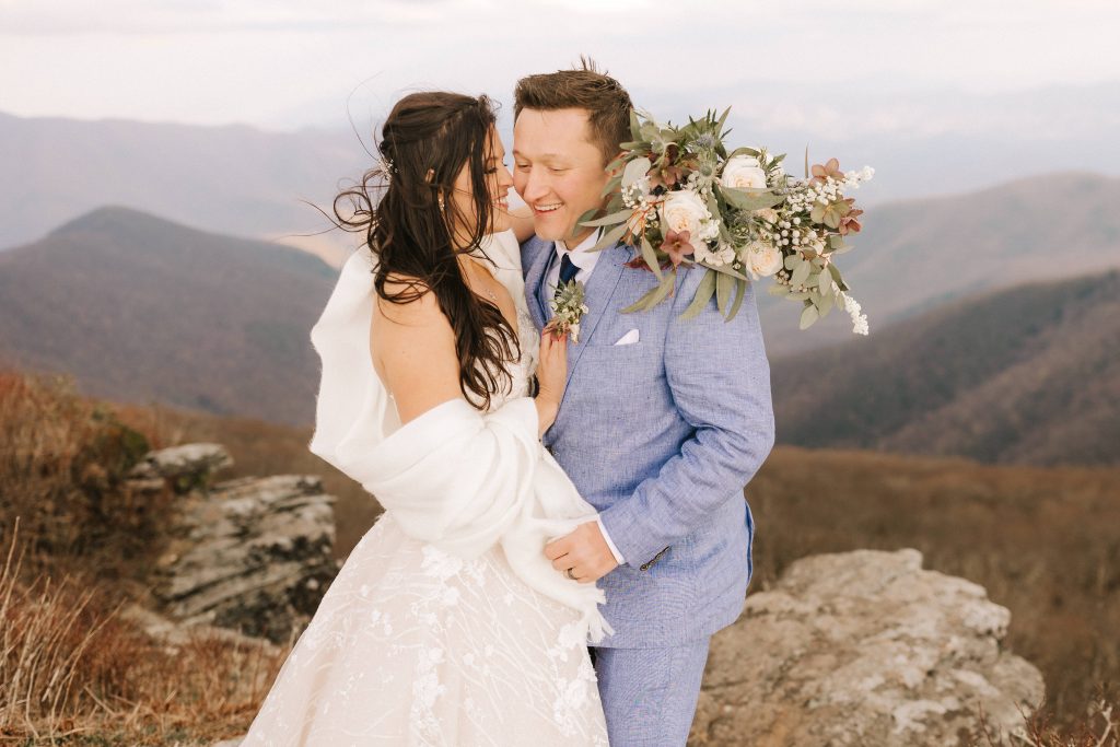 bride and groom laugh together at Craggy Pinnacle in Asheville, NC