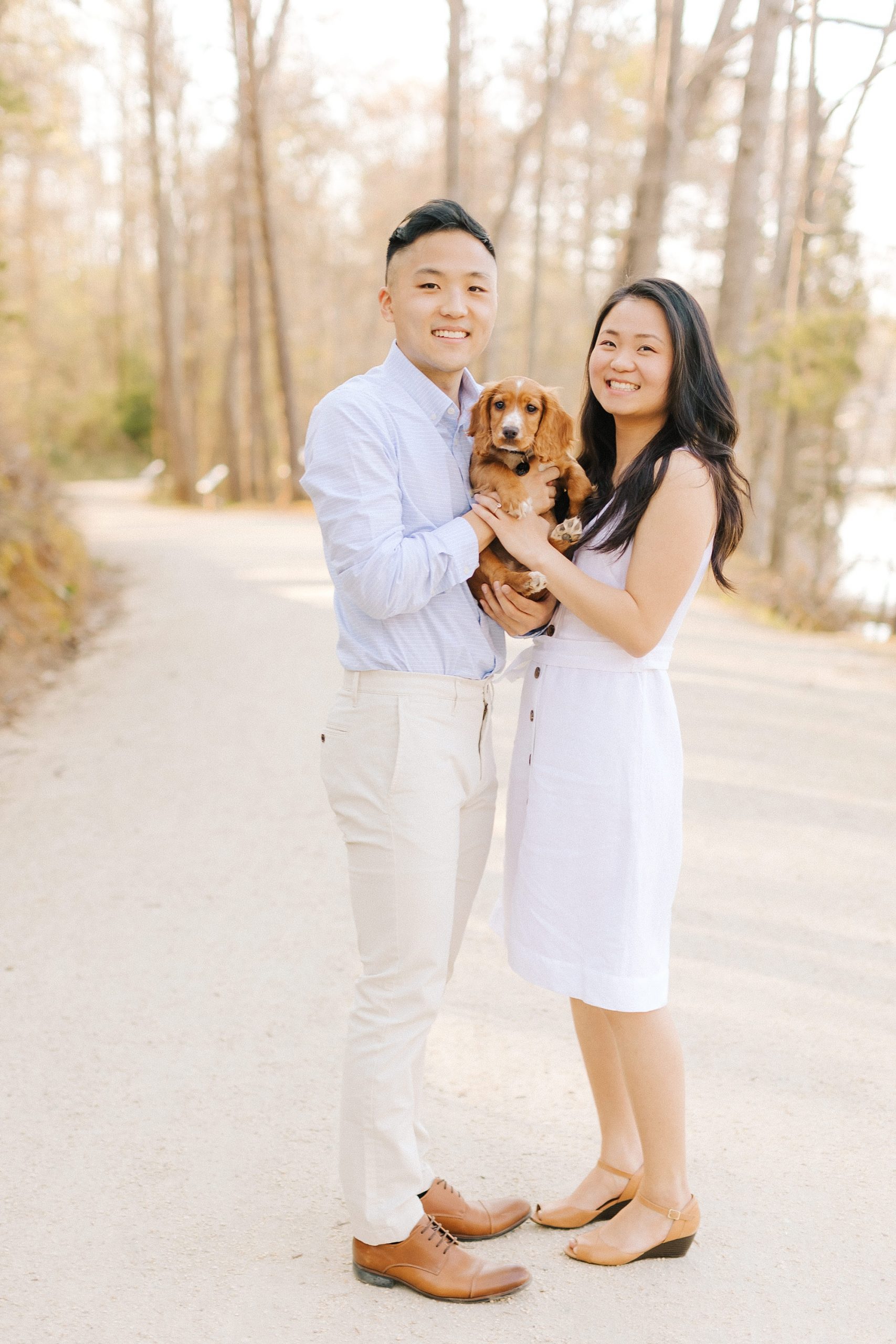 bride and groom hold puppy during NC engagement photos