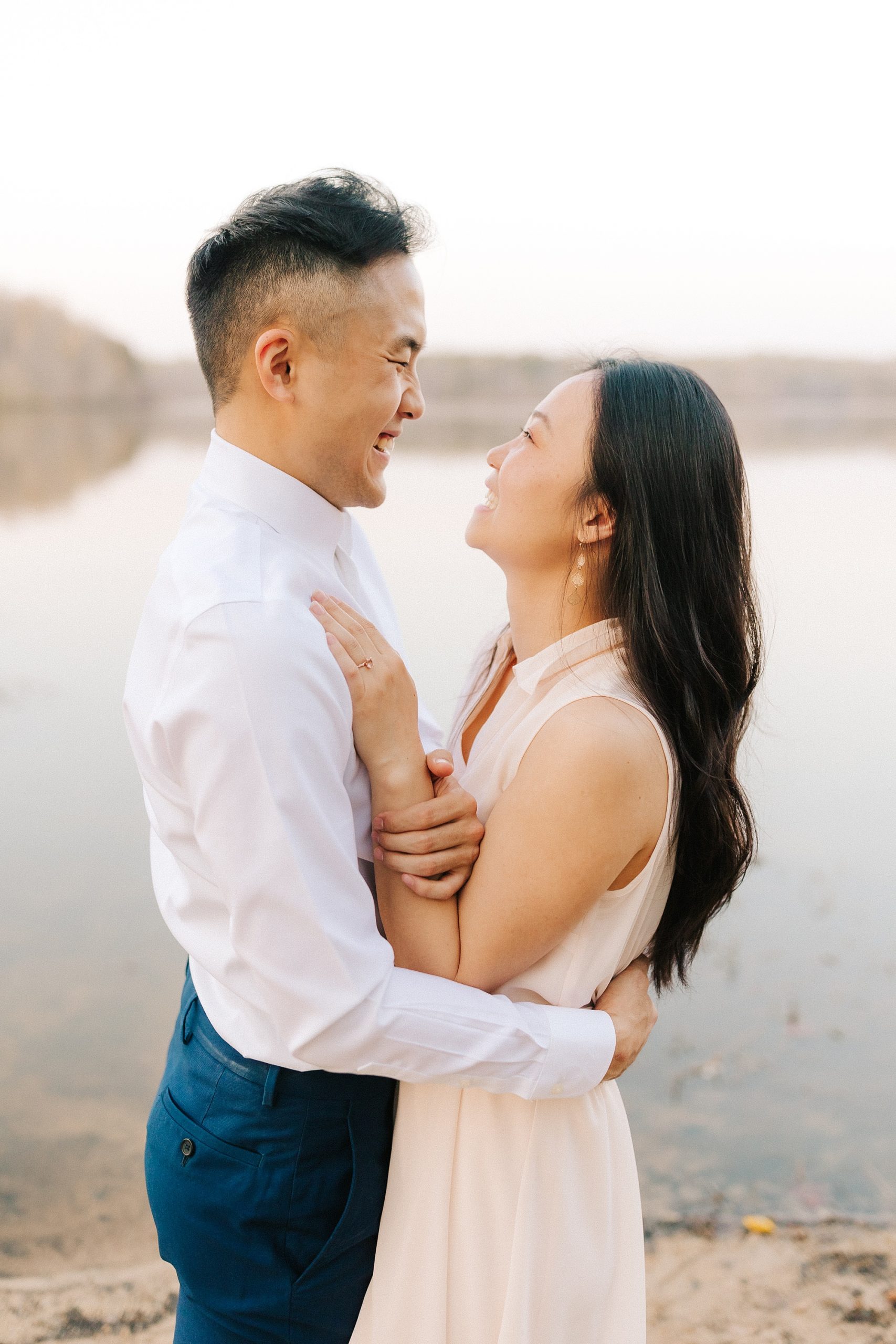 engaged couple laughs together at Salem Lake