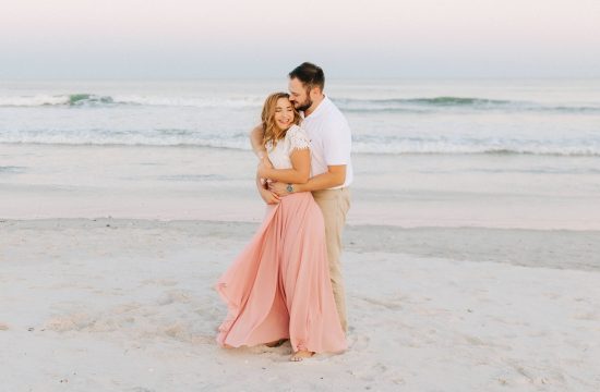 engaged couple dances on Wrightsville Beach during Wilmington engagement session