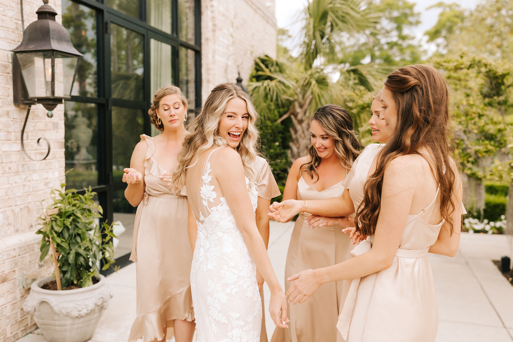 bride looks over her shoulder after first look with bridesmaids