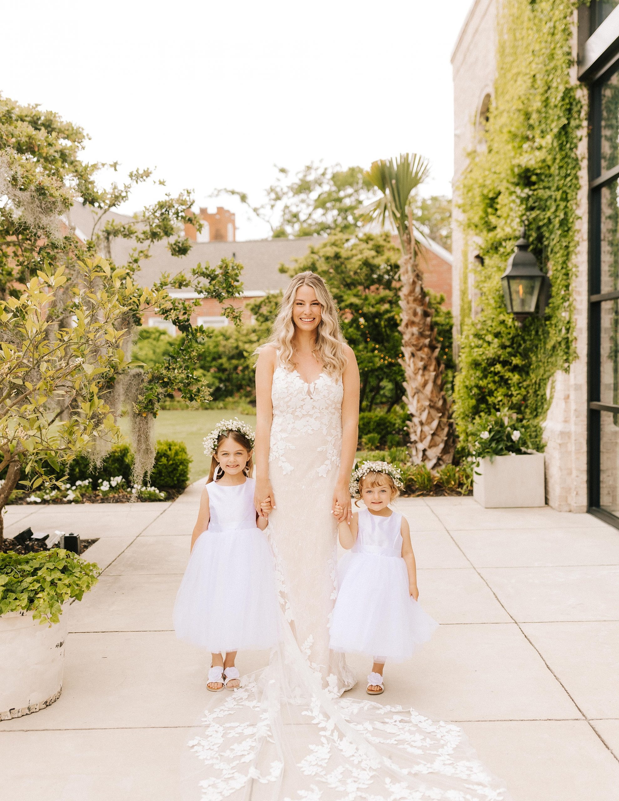 bride poses with two flower girls outside Wrightsville Manor