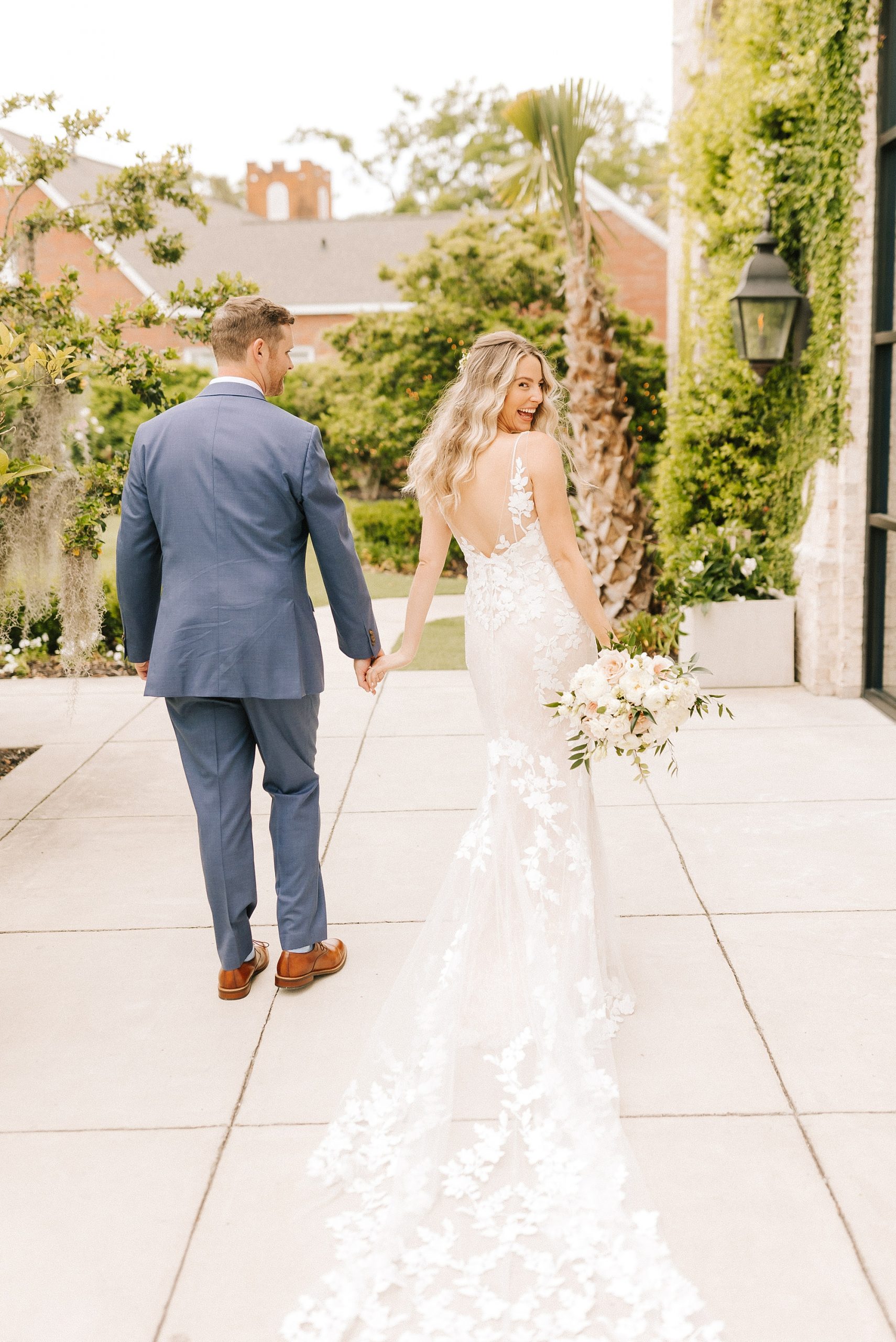 newlyweds walk along Wrightsville Manor patio