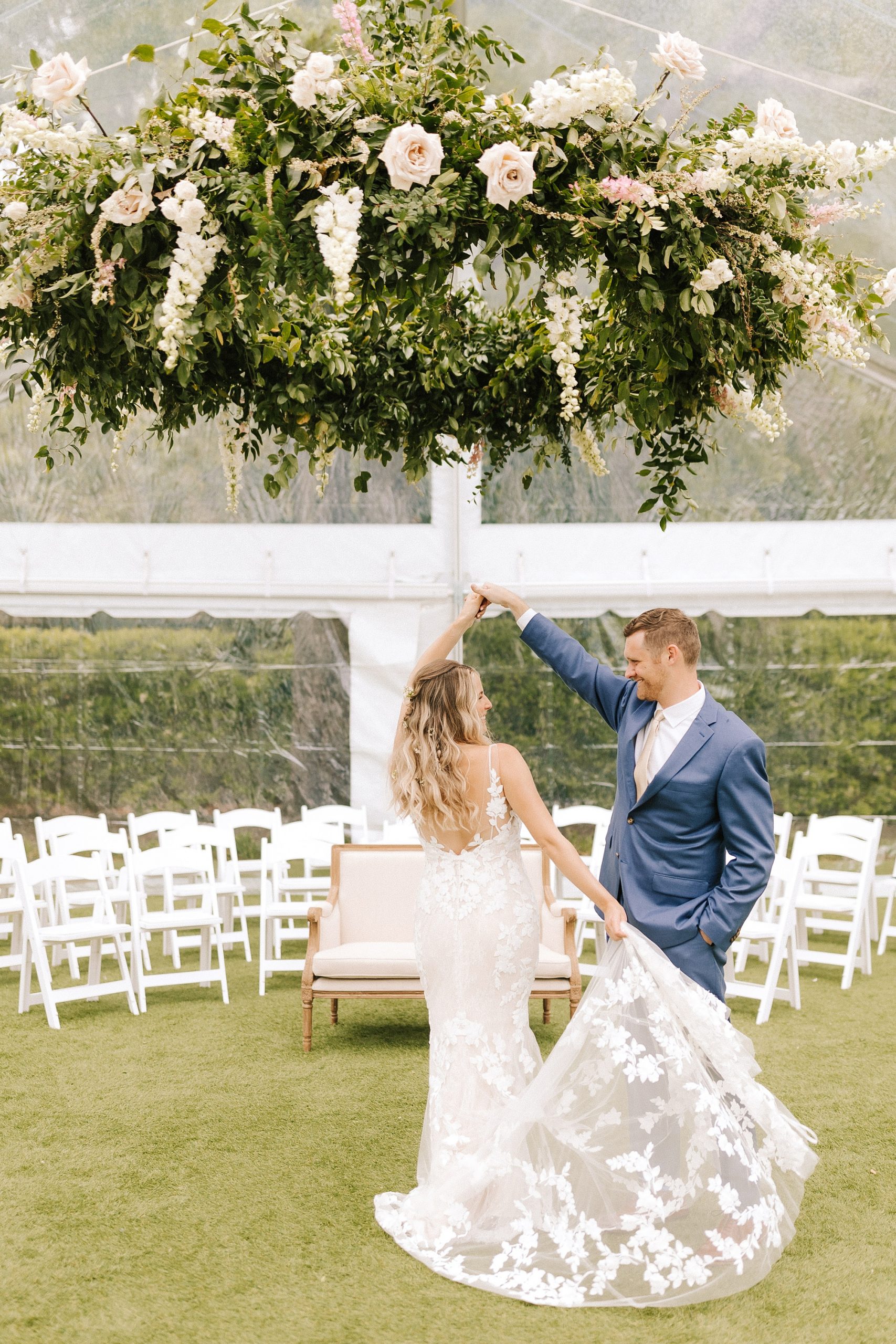 groom twirls bride under tent at Wrightsville Manor