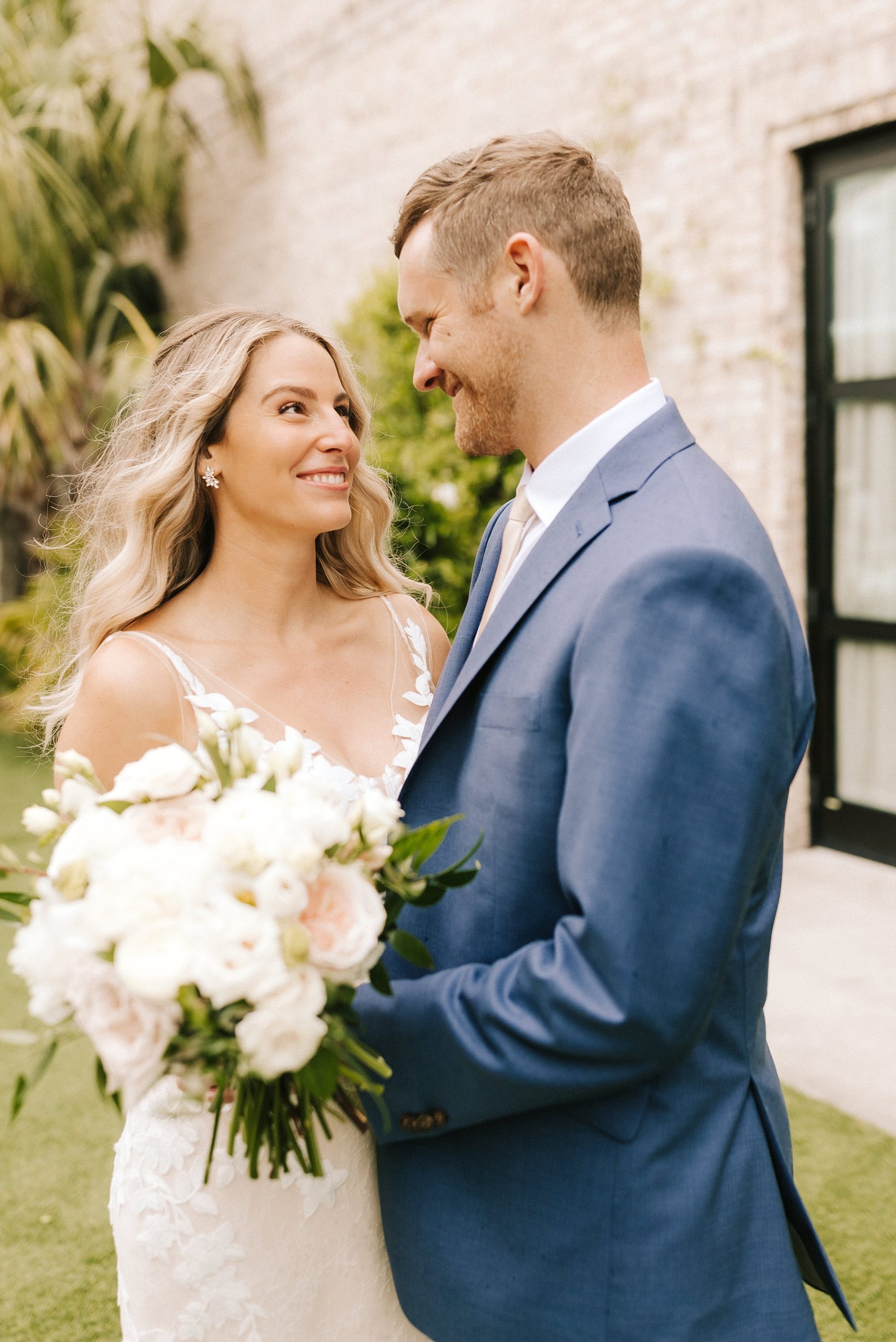 newlyweds laugh together outside Wrightsville Manor