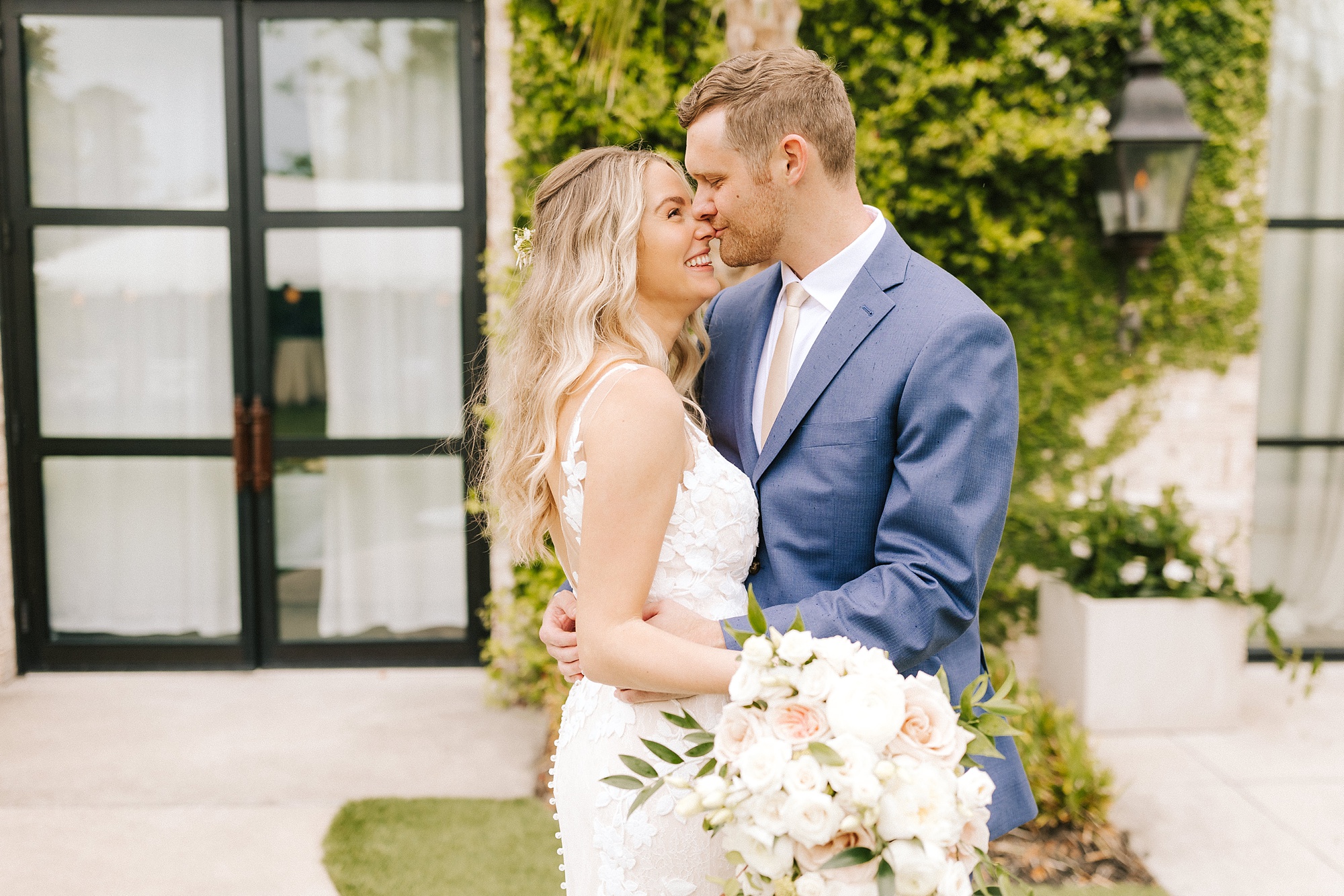 bride and groom lean in for a kiss during spring Wrightsville Manor wedding photos 