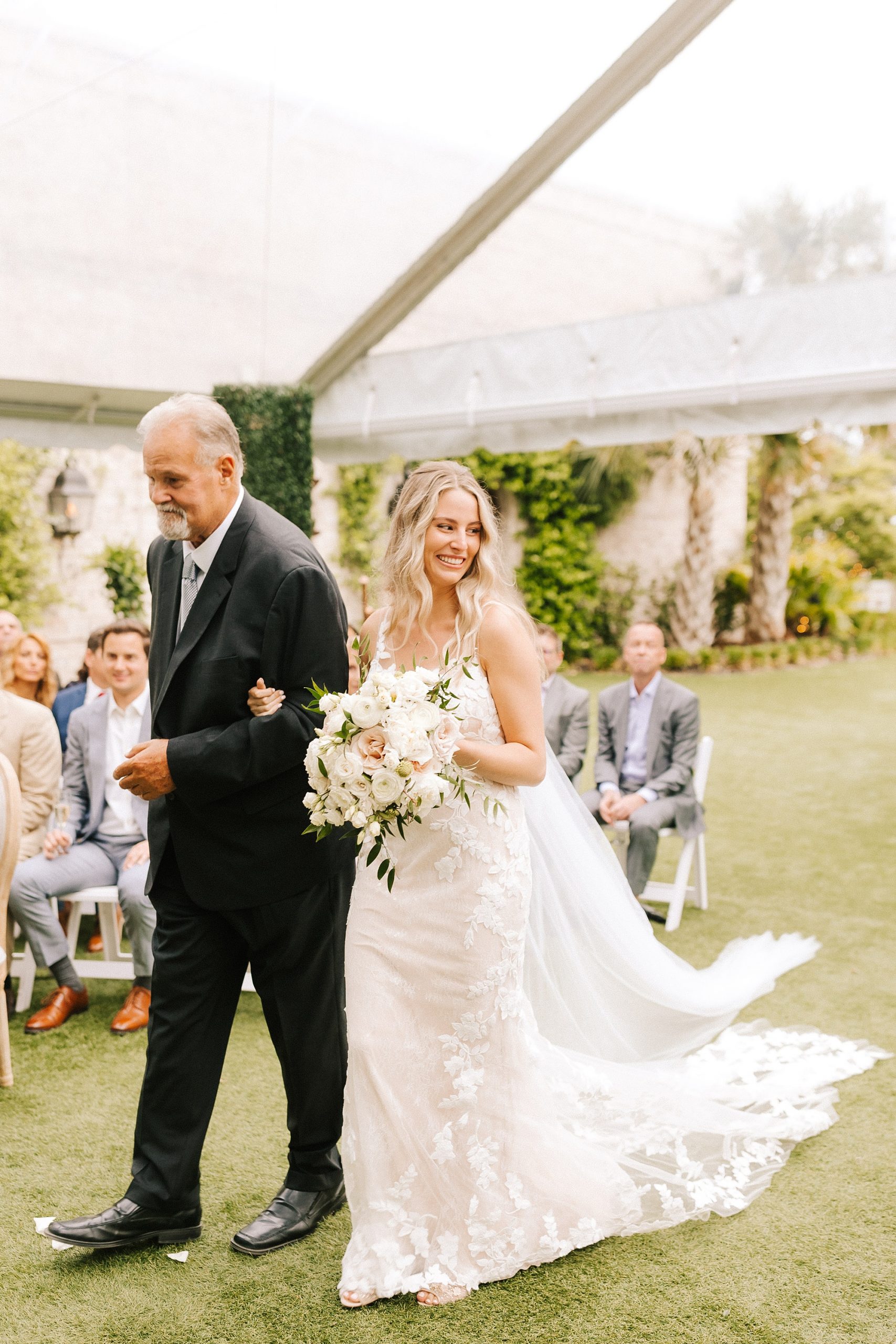 bride walks down the aisle with father during Wrightsville Manor wedding ceremony 