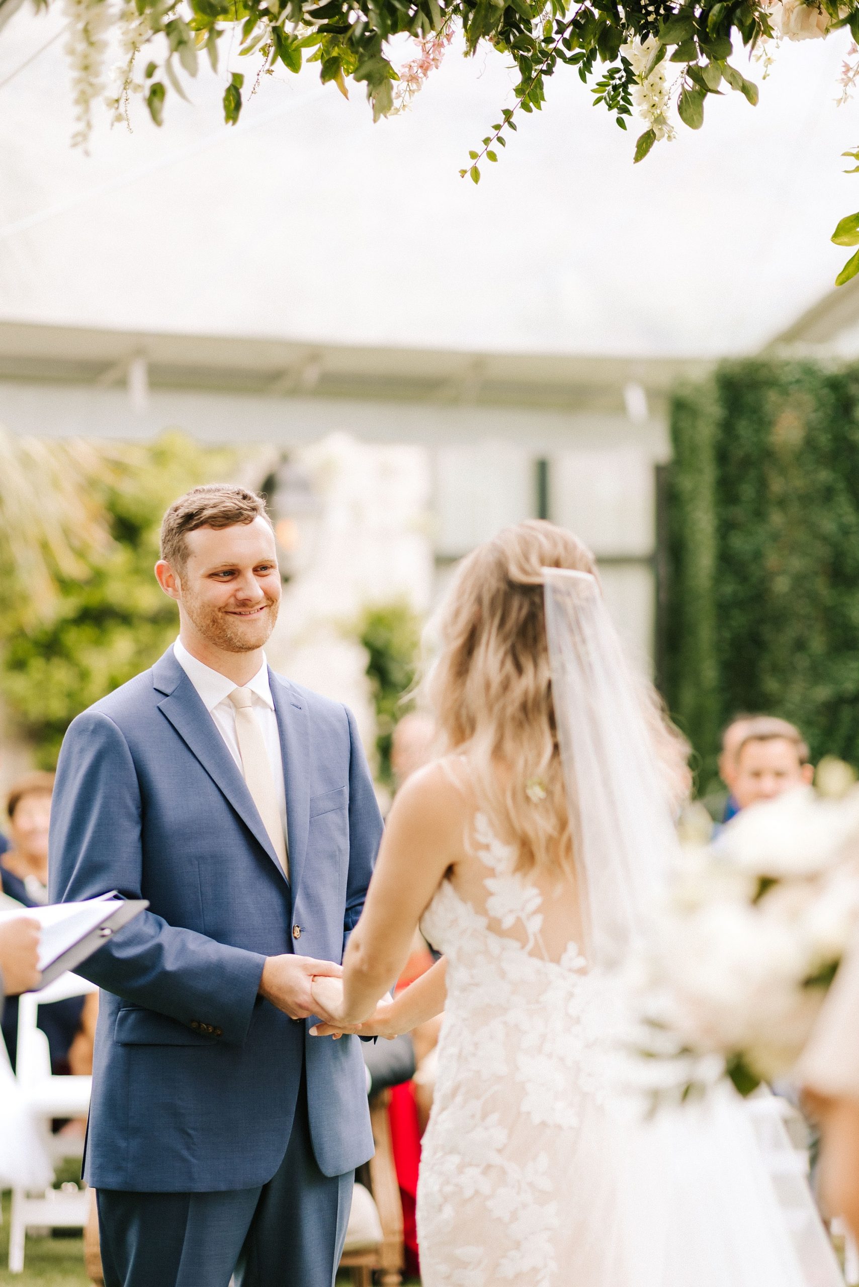 groom looks at bride during spring wedding ceremony 
