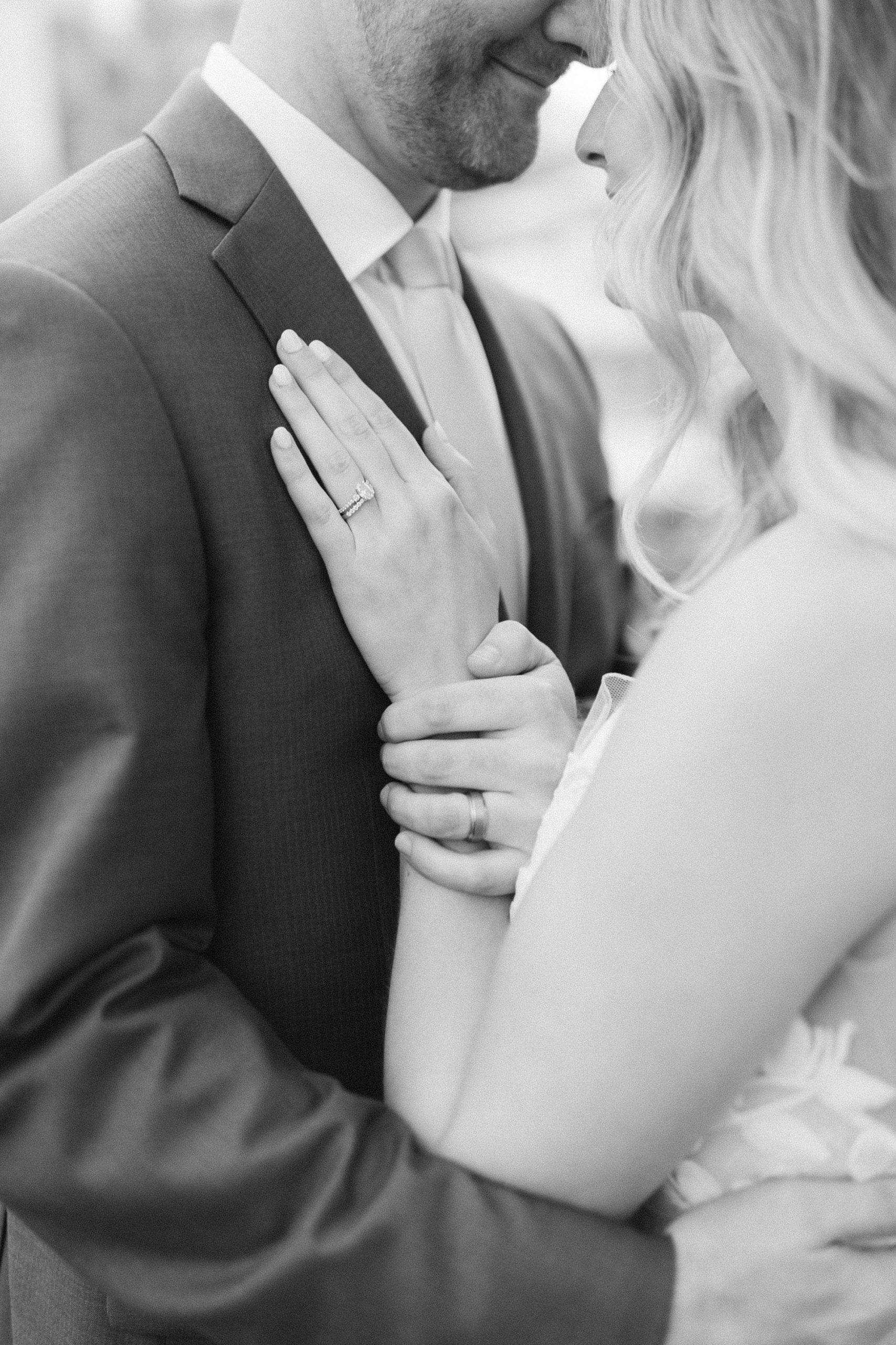 bride lays hand on groom's chest after wedding ceremony 